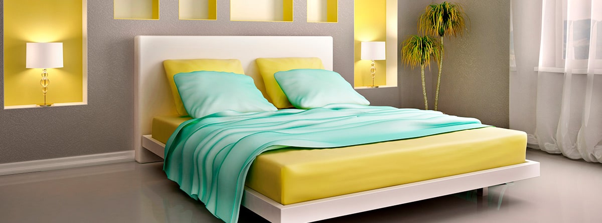 Dormitorio en colores amarillo y turquesa con cabecero de madera entelado