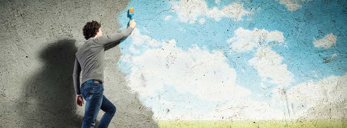 Hombre en una escalera haciendo una pintura 3D en una pared