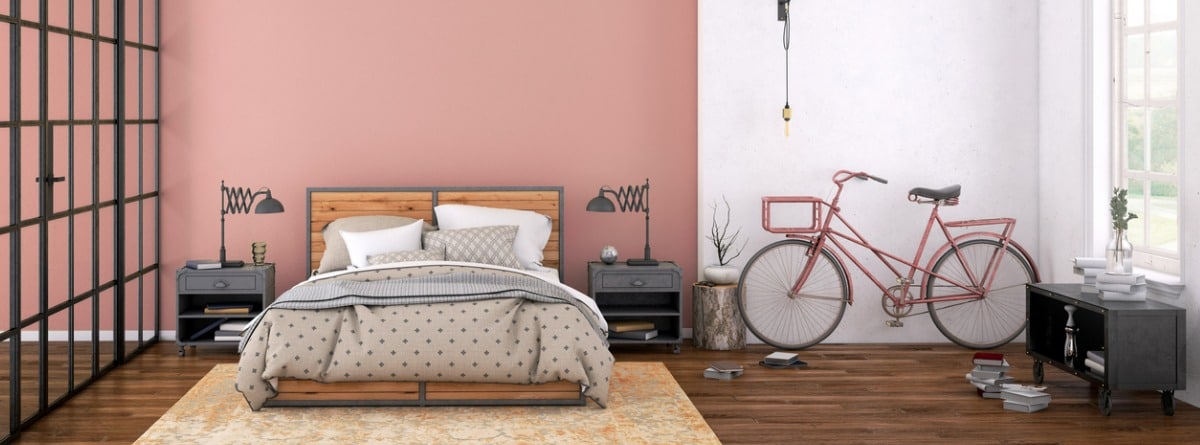 dormitorio con la pared rosa palo y los muebles grises
